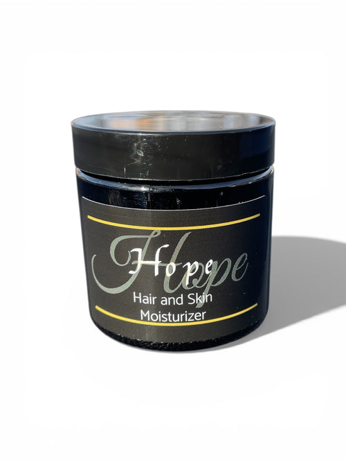 Sample size 2 oz. Black jar of 'Hope' hair and skin moisturizer on a white background