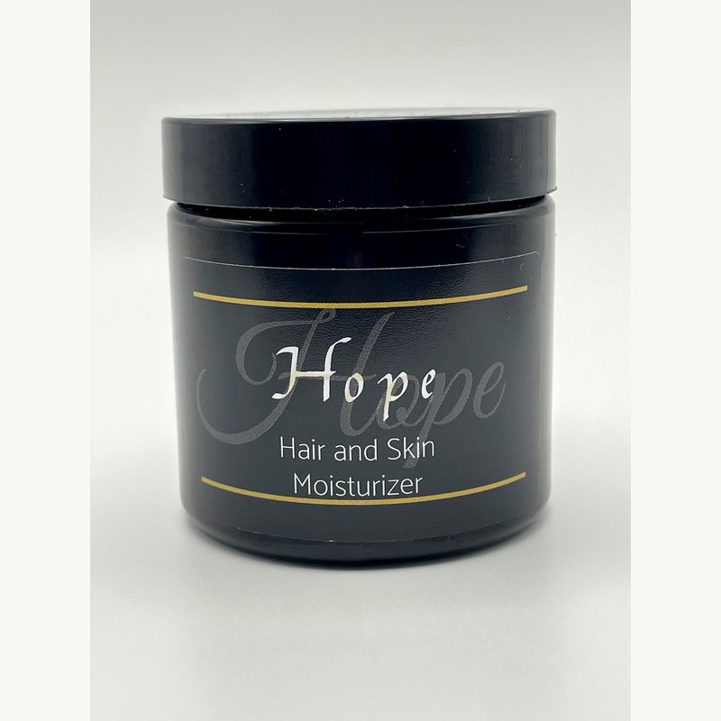 Black jar of 'Hope' hair and skin moisturizer on a white background